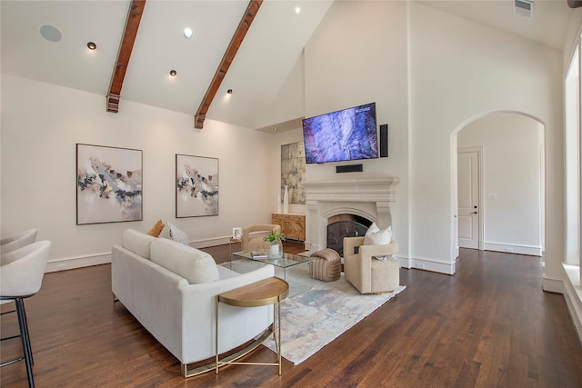 living room with visible vents, high vaulted ceiling, wood finished floors, arched walkways, and a fireplace