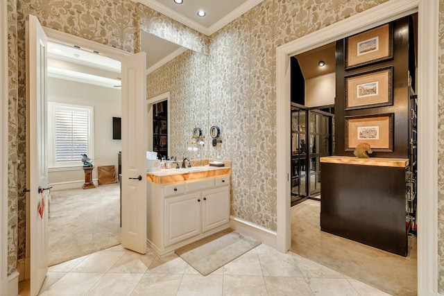 bathroom featuring vanity, ornamental molding, and tile patterned flooring