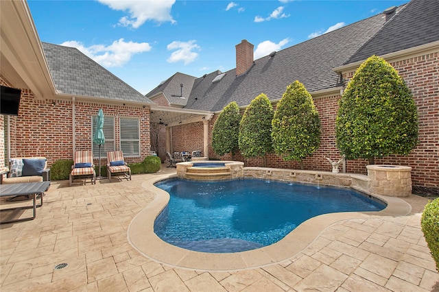 view of swimming pool with a pool with connected hot tub and a patio area