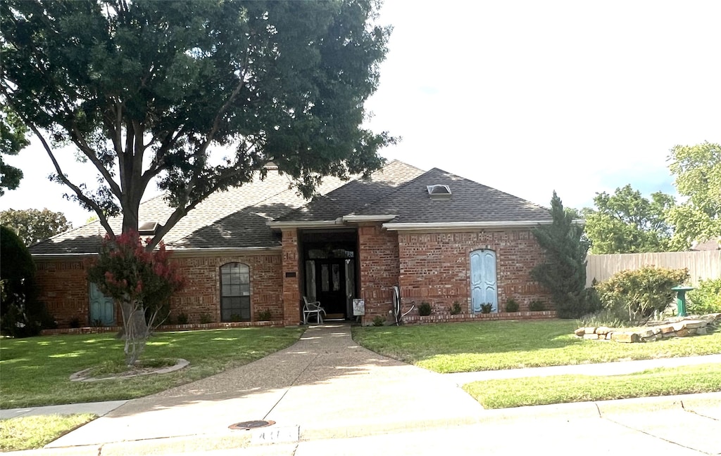 ranch-style house with a front lawn