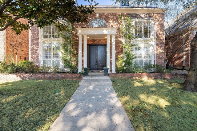 doorway to property with a lawn