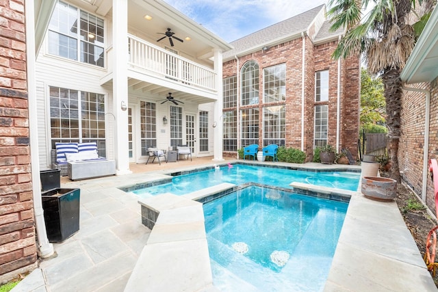 view of swimming pool featuring ceiling fan, a patio area, an outdoor living space, and an in ground hot tub