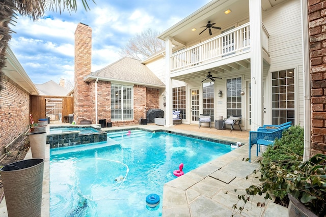 view of pool featuring ceiling fan, an in ground hot tub, and a patio