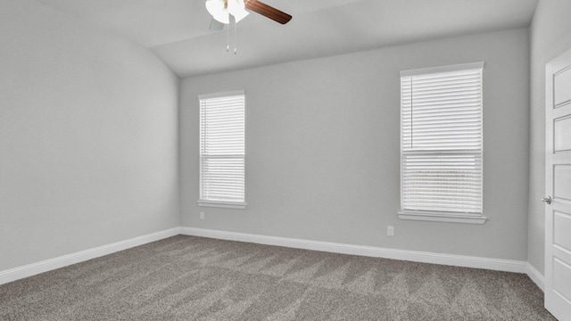 spare room with ceiling fan, lofted ceiling, and light carpet