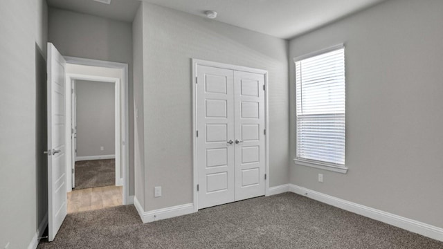 unfurnished bedroom with carpet floors and a closet