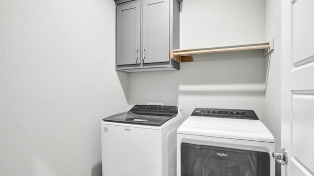 laundry area featuring cabinets and washer and dryer