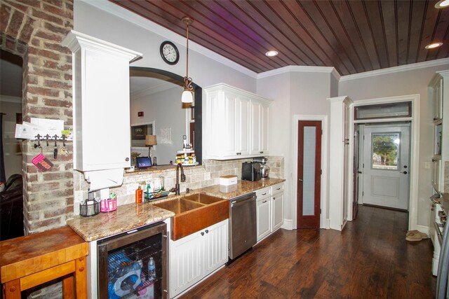 4201 Linda Ln, Shreveport, LA 71107 - kitchen featuring appliances with stainless steel finishes, wall chimney range hood, independent washer and dryer, white cabinets, and tasteful backsplash