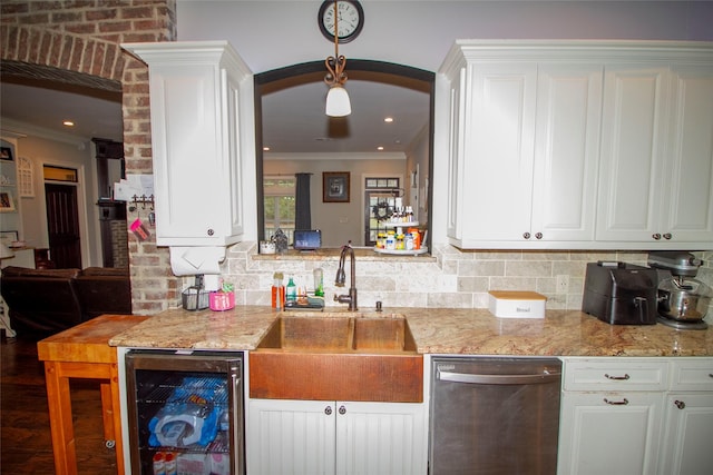 kitchen featuring stainless steel dishwasher, sink, white cabinets, beverage cooler, and light stone counters