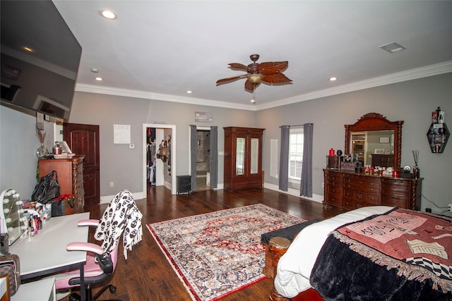 bedroom featuring ceiling fan, a spacious closet, dark wood-type flooring, ornamental molding, and a closet