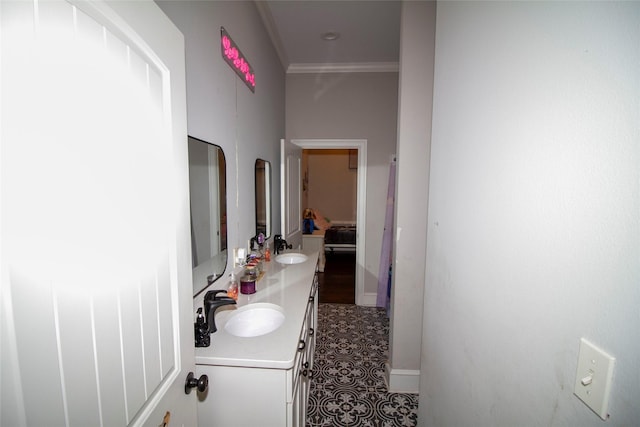 bathroom with vanity, ornamental molding, and tile patterned flooring