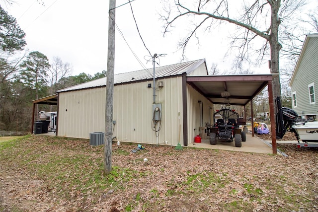 view of outbuilding with a carport and central AC