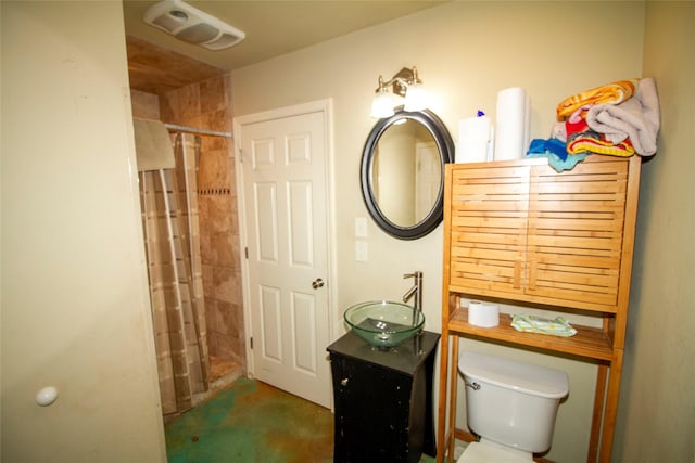 bathroom featuring toilet, vanity, and curtained shower