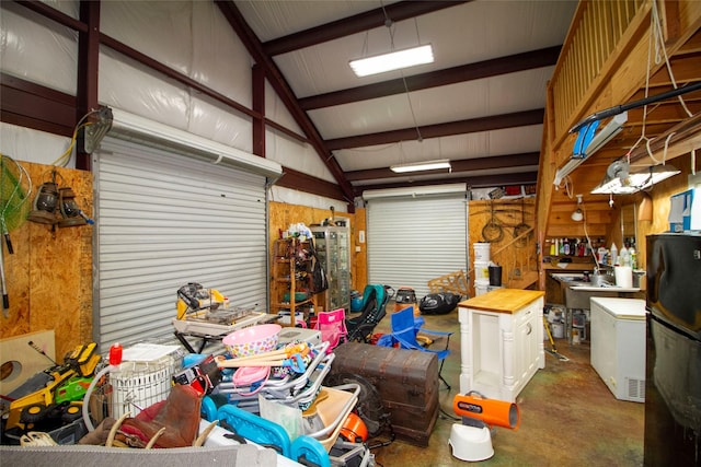 garage with wood walls and a workshop area