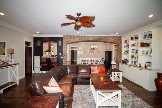 living room featuring brick wall, ceiling fan with notable chandelier, and ornamental molding