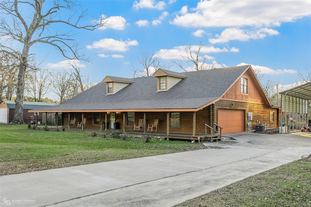 view of front of property with central AC unit, covered porch, a garage, and a front yard