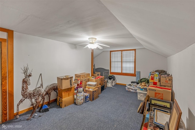 interior space featuring ceiling fan, carpet floors, and lofted ceiling