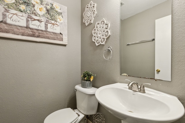 bathroom featuring toilet and sink