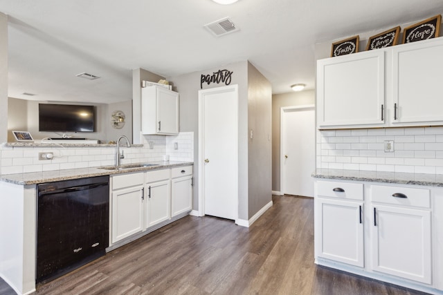 kitchen with sink, white cabinetry, black dishwasher, and tasteful backsplash