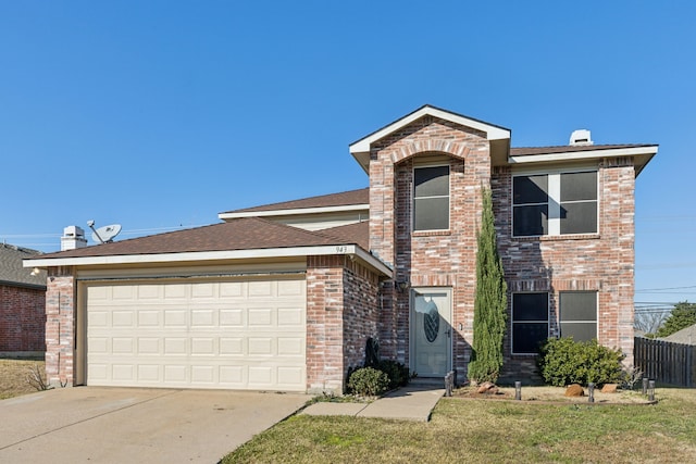 view of front of property featuring a front lawn and a garage