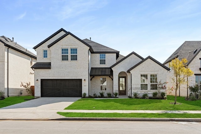 view of front of home with a front lawn and a garage