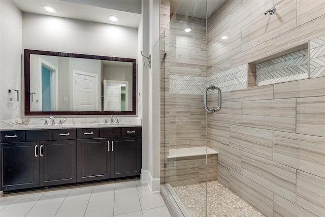 bathroom featuring walk in shower, vanity, and tile patterned flooring