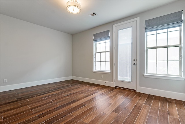 empty room featuring dark hardwood / wood-style flooring