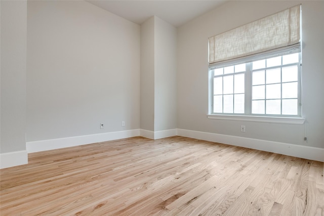 spare room with a healthy amount of sunlight and light hardwood / wood-style floors