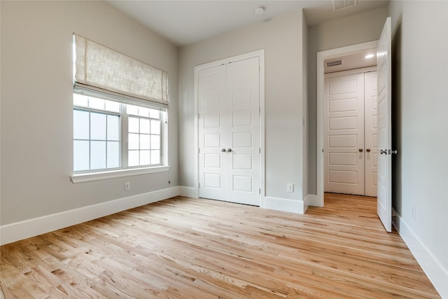 unfurnished bedroom featuring a closet and light hardwood / wood-style flooring