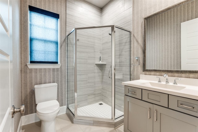 bathroom featuring toilet, tile patterned floors, walk in shower, and vanity