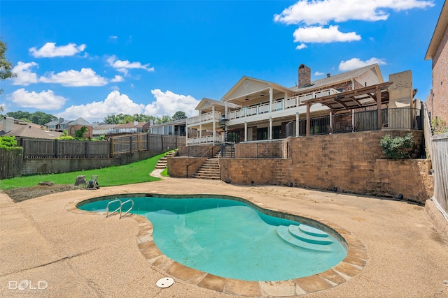 view of swimming pool with a patio and a yard