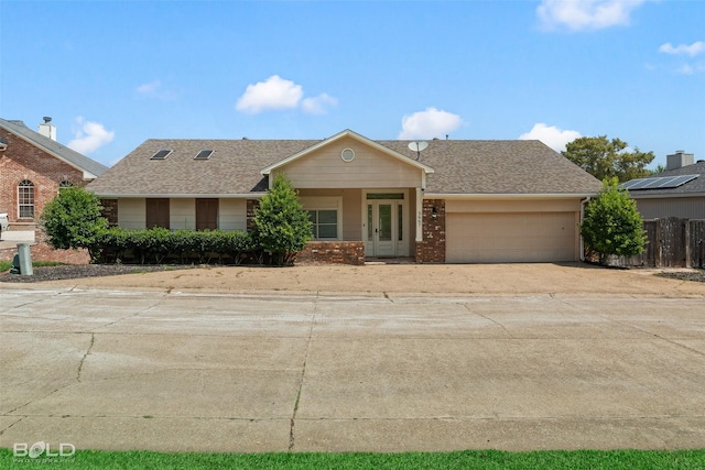 ranch-style home featuring a garage