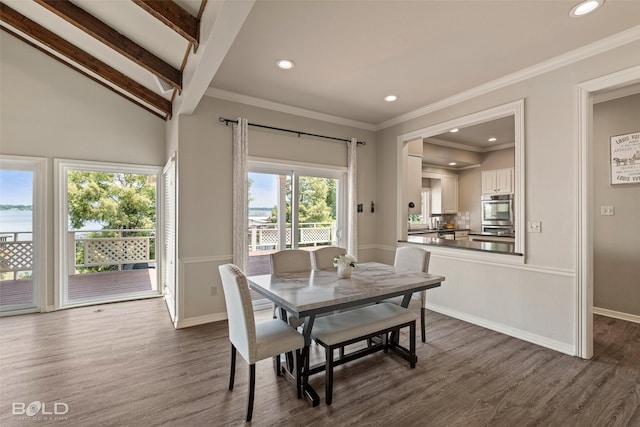 dining room featuring vaulted ceiling with beams, dark hardwood / wood-style floors, and ornamental molding