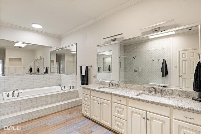 bathroom featuring vanity, independent shower and bath, crown molding, and hardwood / wood-style flooring