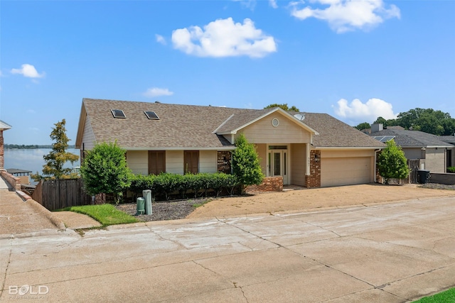 view of front facade with a garage and a water view