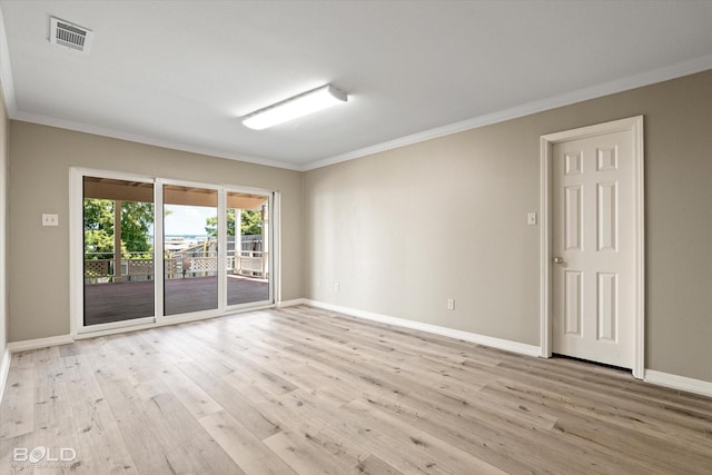 unfurnished room with ornamental molding and light wood-type flooring