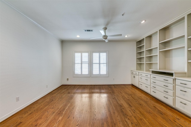 interior space featuring ceiling fan, crown molding, built in features, and light hardwood / wood-style flooring