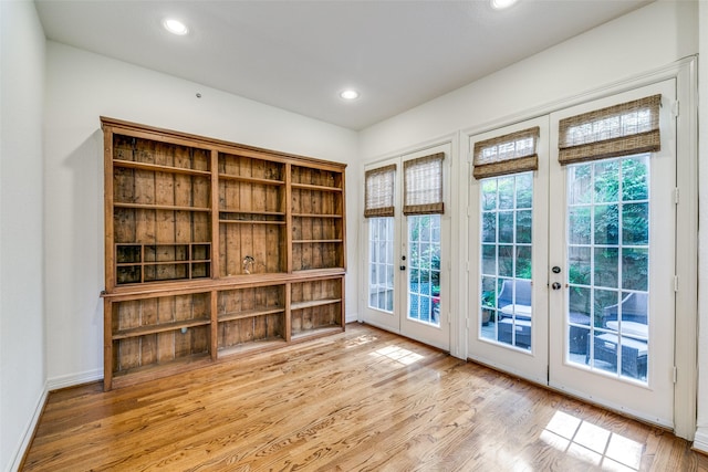 doorway with light hardwood / wood-style floors and french doors