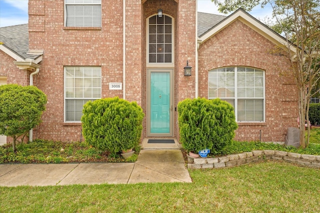 property entrance with a yard