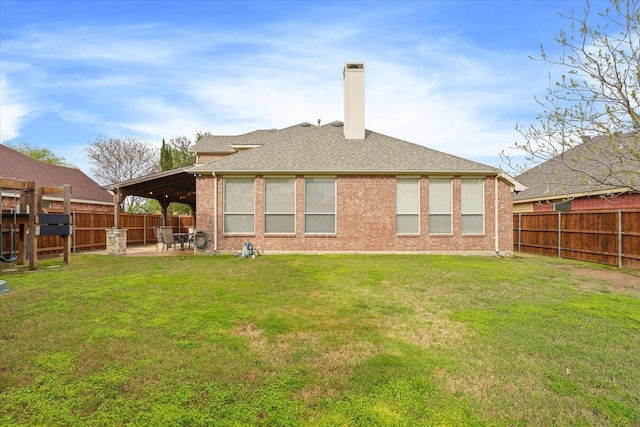 rear view of property featuring a lawn and a patio