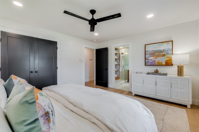 bedroom with ceiling fan, light hardwood / wood-style floors, and ensuite bath