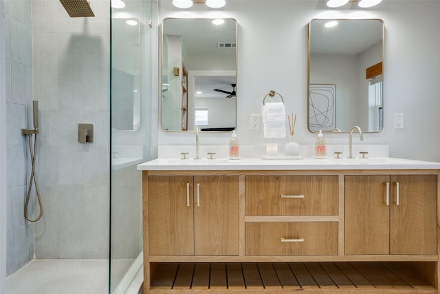 bathroom with ceiling fan, vanity, and a shower