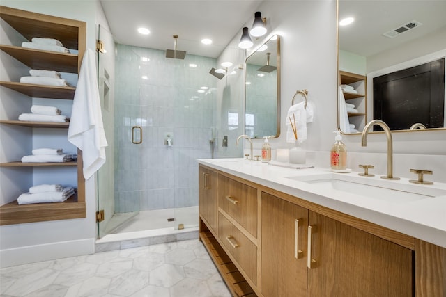 bathroom featuring a shower with shower door and vanity