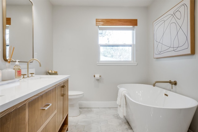 bathroom featuring a tub to relax in, vanity, toilet, and tile patterned flooring