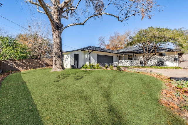 view of front of house with a garage and a front yard