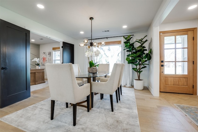 dining room with a chandelier and light hardwood / wood-style floors