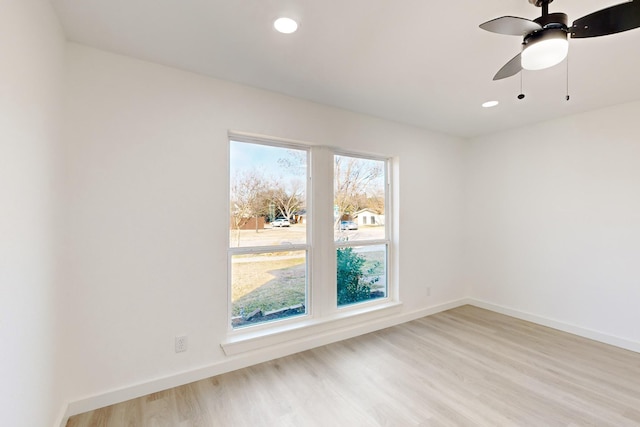 spare room featuring ceiling fan and light hardwood / wood-style flooring