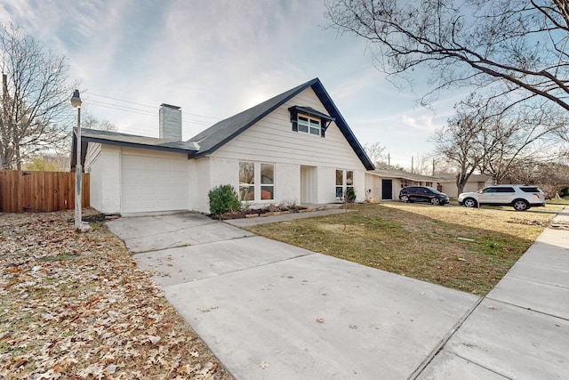 view of front of house with a front yard and a garage