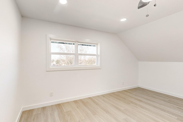 additional living space featuring lofted ceiling, light wood-type flooring, and ceiling fan