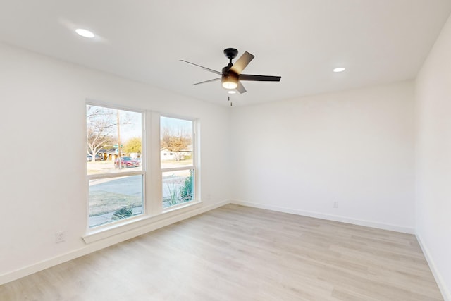 spare room with ceiling fan and light hardwood / wood-style floors