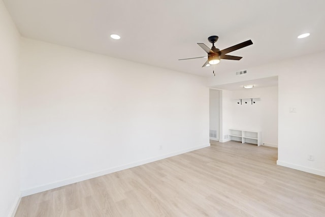 empty room with ceiling fan and light hardwood / wood-style floors